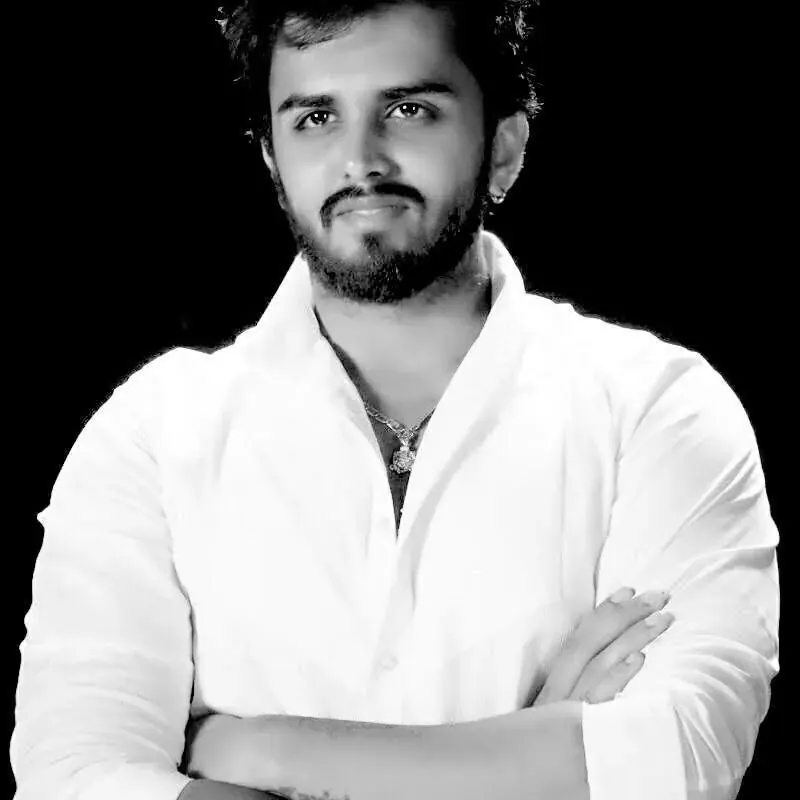 Utkarsh Jayesh Suratwala — Signature Portrait. Classic black & white portrait of Online Director Utkarsh Jayesh Suratwala., Utkarsh Jayesh Suratwala